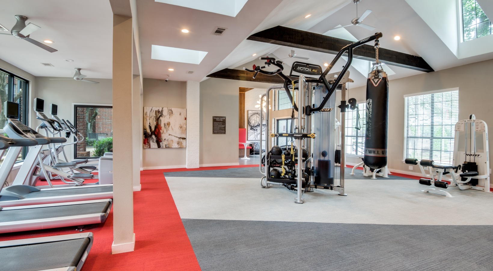 a gym room with tread machines and exercise equipment at The Hyde Park at Valley Ranch