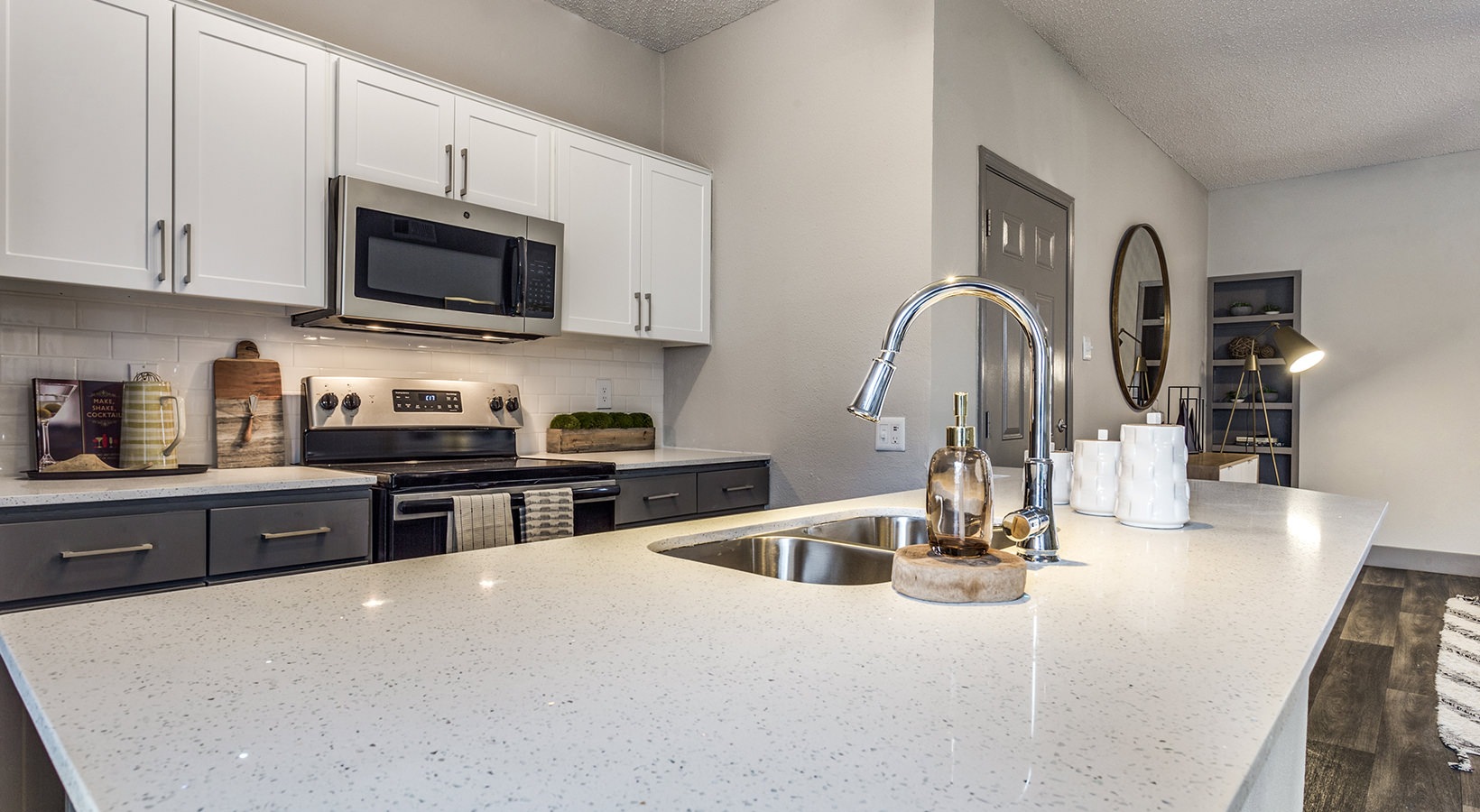 a kitchen with stainless steel appliances and a sink at The Hyde Park at Valley Ranch