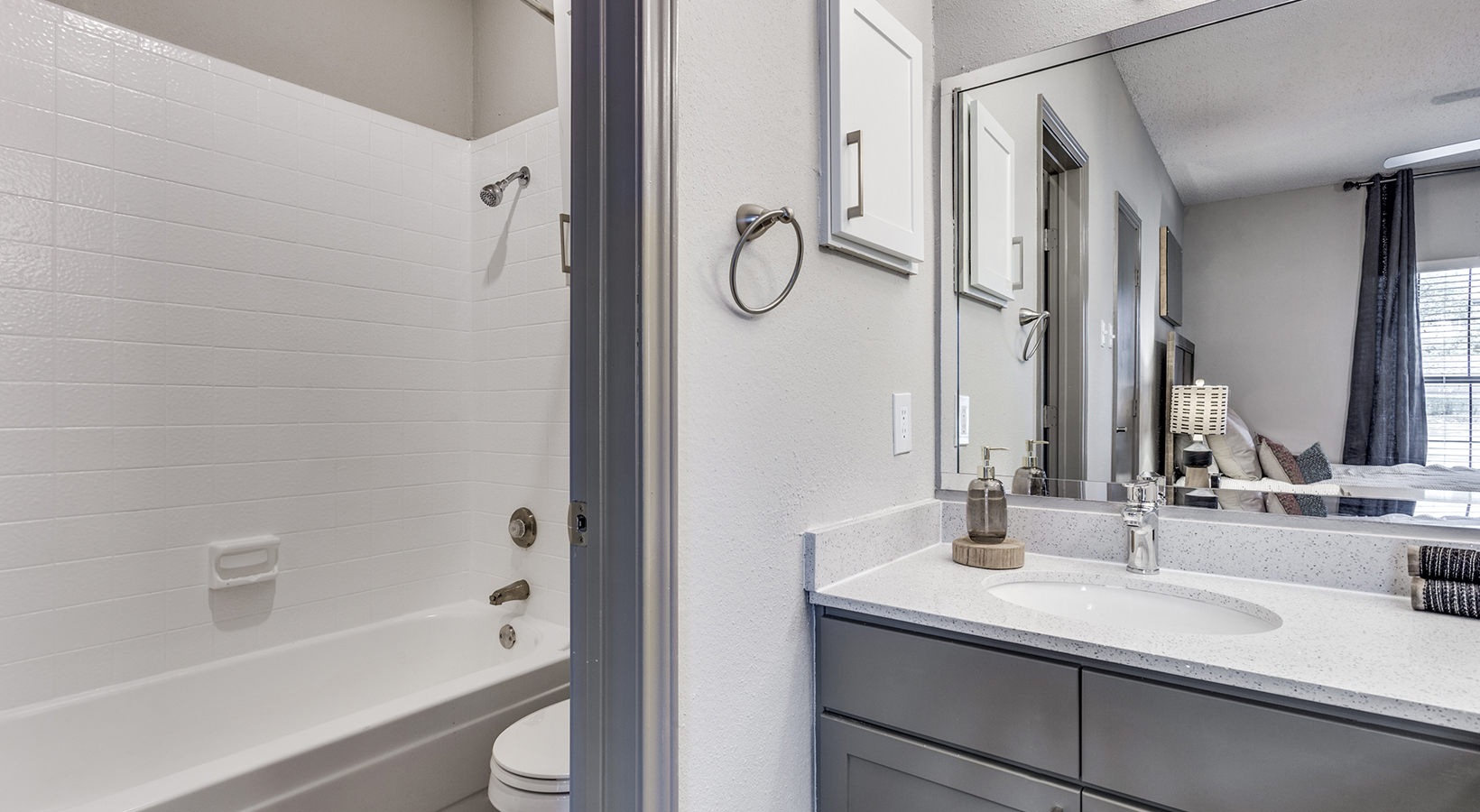 a bathroom with a sink, toilet and shower at The Hyde Park at Valley Ranch