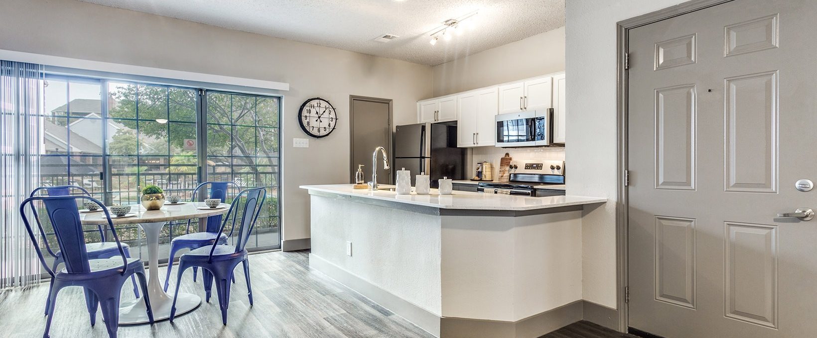 a kitchen and dining area in a new apartment at The Hyde Park at Valley Ranch