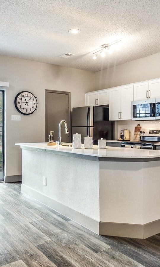 a kitchen and dining area in a new apartment at The Hyde Park at Valley Ranch